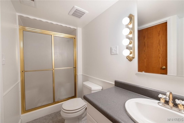 full bathroom featuring visible vents, toilet, and a shower with shower door