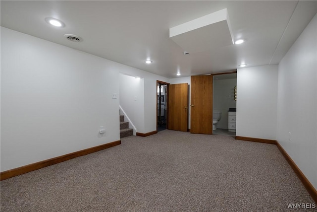 empty room with visible vents, baseboards, stairway, carpet floors, and recessed lighting