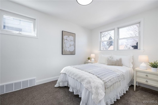 carpeted bedroom with visible vents and baseboards