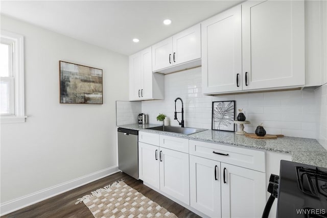 kitchen with dark wood-style floors, baseboards, a sink, white cabinets, and stainless steel dishwasher