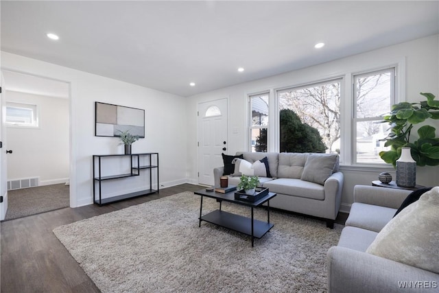 living room with dark wood finished floors, recessed lighting, visible vents, and baseboards