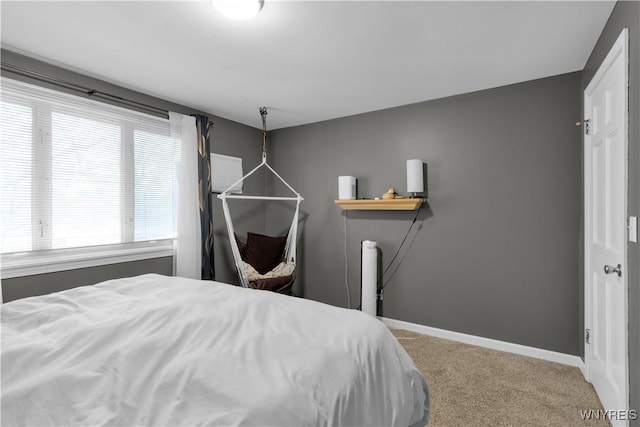 bedroom featuring baseboards and carpet floors