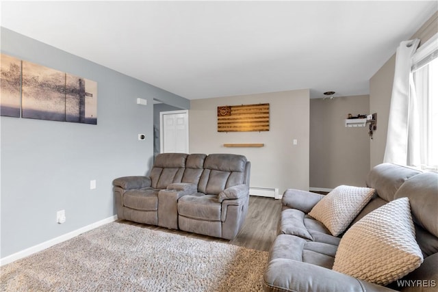 living room with a baseboard radiator, baseboards, and wood finished floors