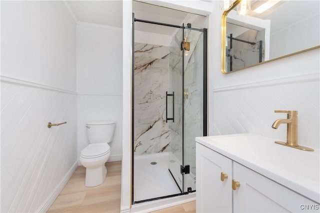 full bathroom featuring vanity, toilet, wood finished floors, and a marble finish shower