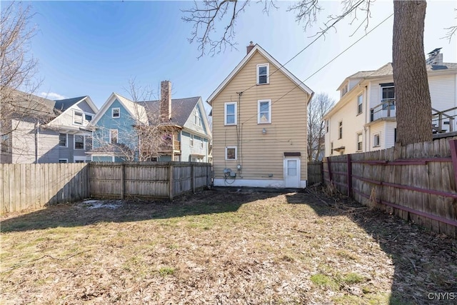 rear view of property with a fenced backyard