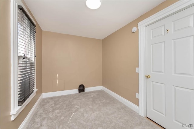 interior space with baseboards and carpet flooring