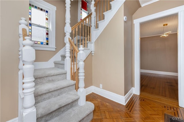 stairway with visible vents and baseboards