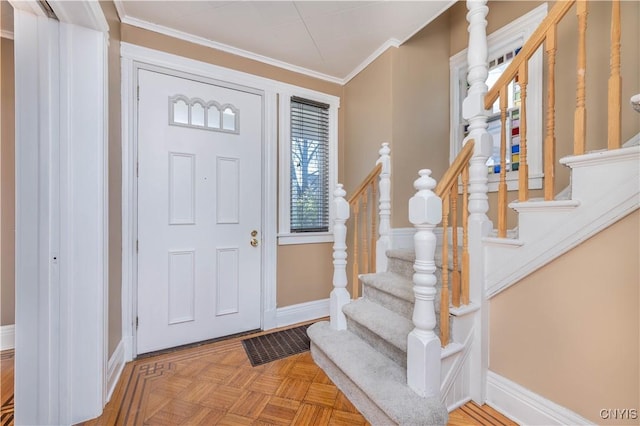 entryway featuring stairs, visible vents, baseboards, and ornamental molding