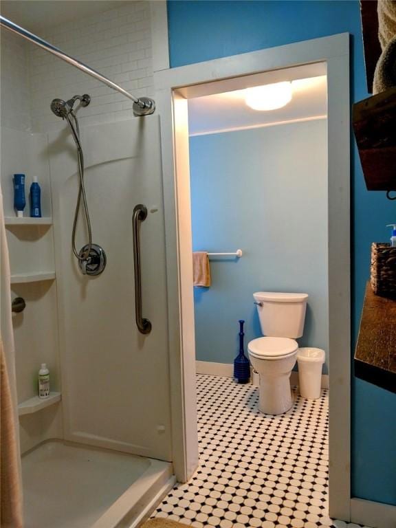 full bath with toilet and a shower stall