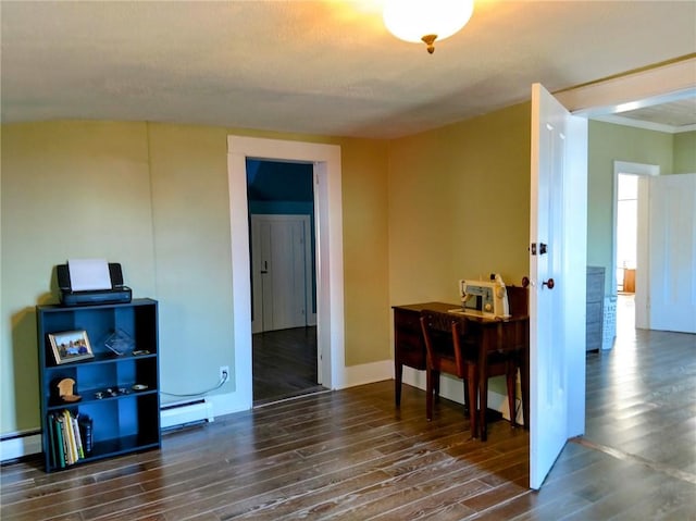 interior space with wood finished floors, baseboards, and a baseboard radiator