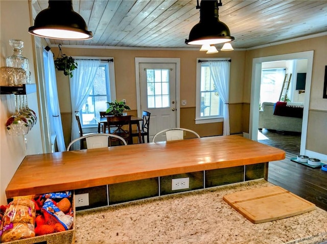 dining area with wood finished floors, wood ceiling, baseboards, and ornamental molding