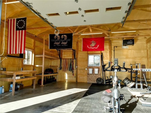 workout area with a garage and wood walls