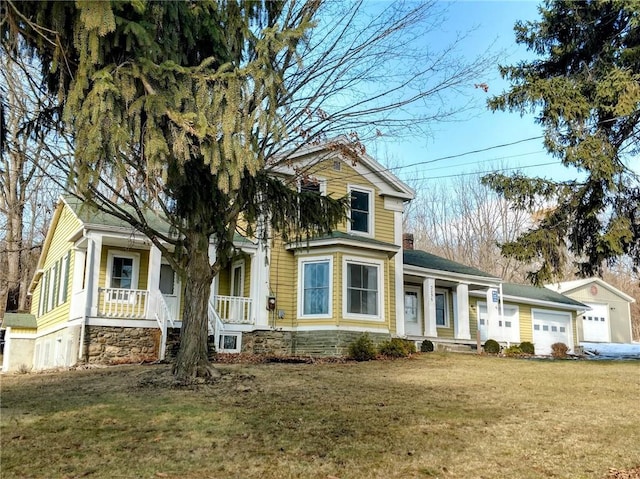 view of front of house with a garage, a porch, and a front yard