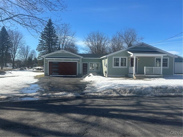 view of front of house with a garage, a porch, and driveway