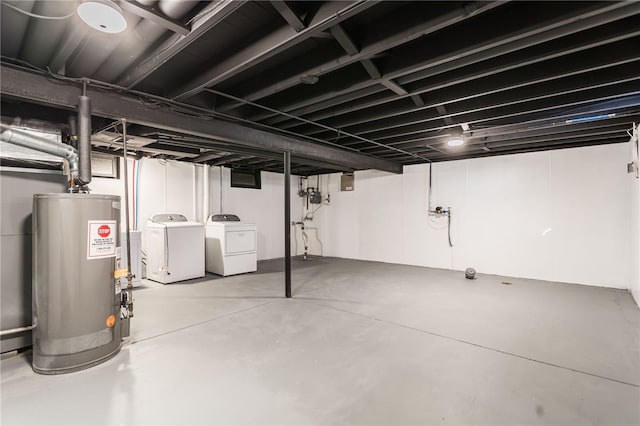 finished basement featuring water heater and washer and clothes dryer