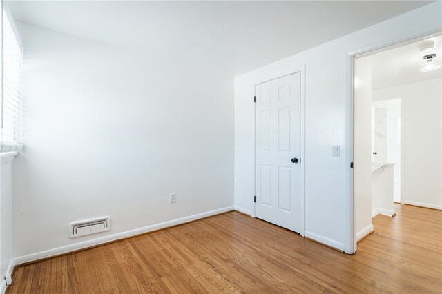 unfurnished bedroom featuring visible vents, baseboards, and light wood-style floors