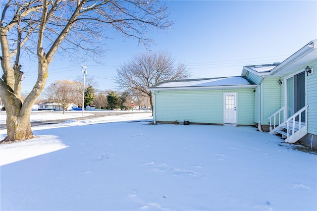 snowy yard featuring entry steps