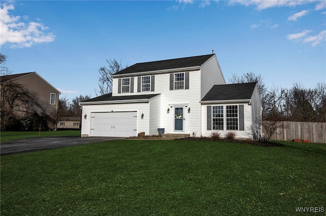 view of front of property with a front yard, an attached garage, fence, and driveway