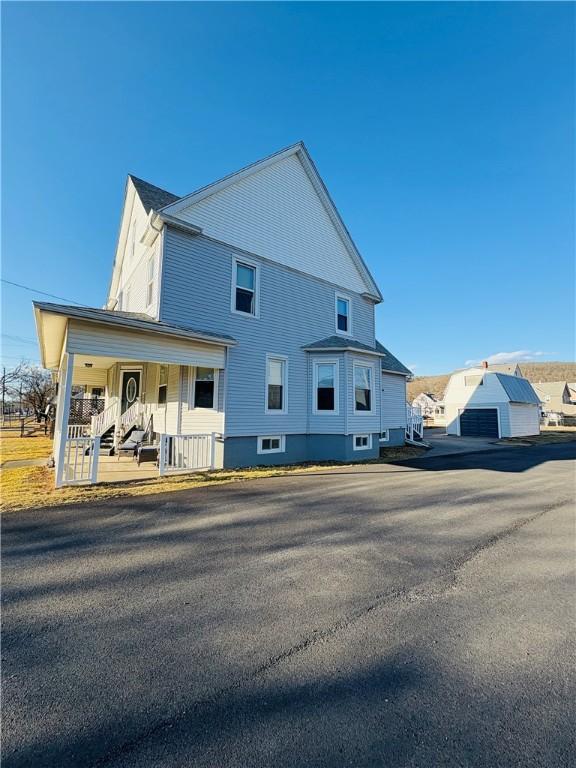 back of property featuring covered porch