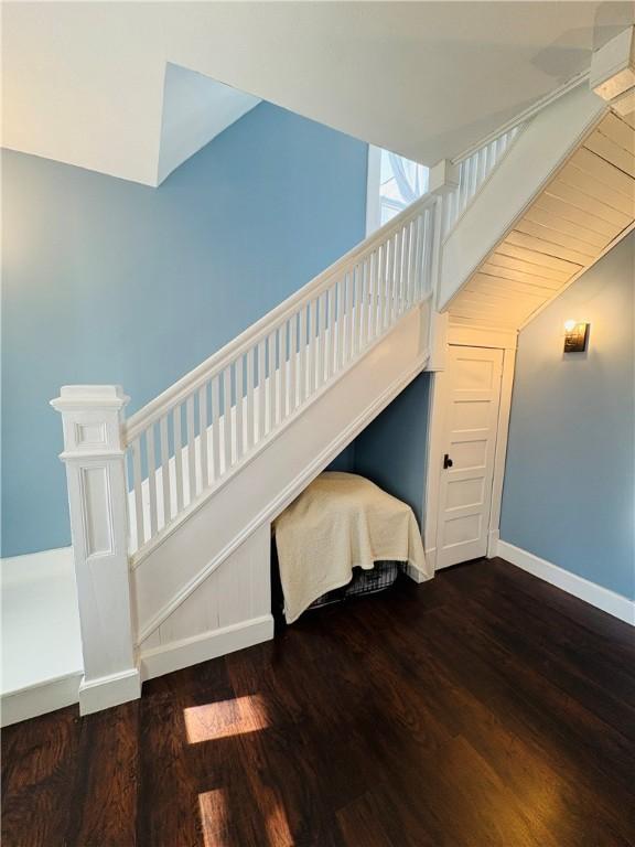 stairway featuring wood finished floors and baseboards