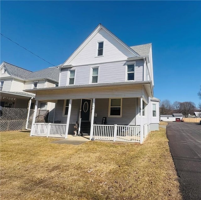 view of front of house featuring a porch and a front lawn