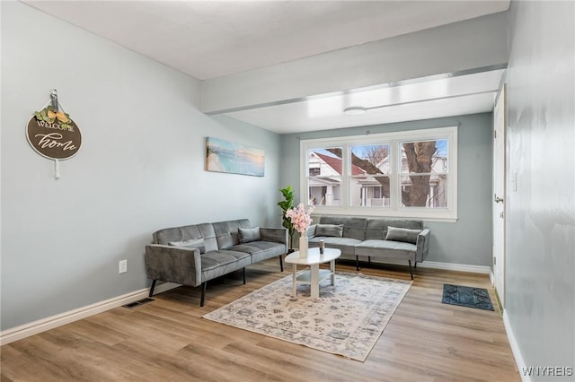 living room with baseboards and wood finished floors