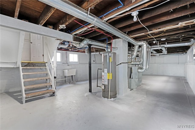 below grade area featuring water heater, stairs, and a sink