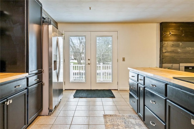 doorway to outside featuring light tile patterned flooring and french doors