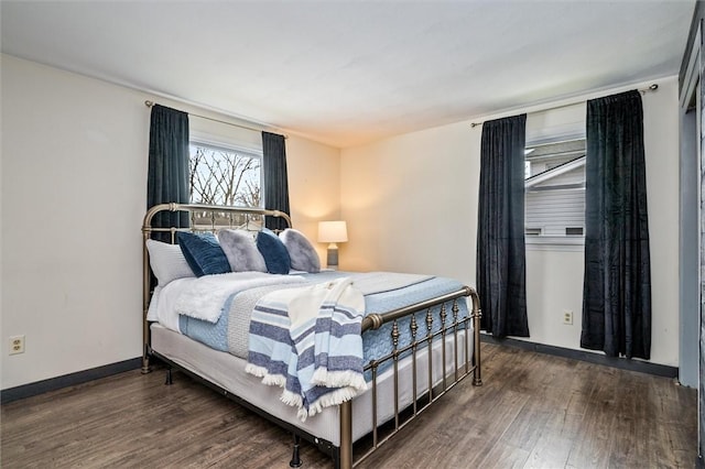 bedroom with baseboards and wood finished floors