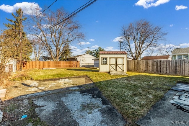 view of yard featuring a fenced backyard, a storage shed, and an outdoor structure