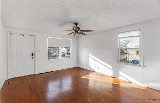 entryway with visible vents, wood-type flooring, a textured ceiling, and a ceiling fan