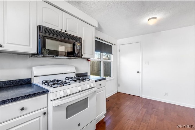 kitchen featuring gas range gas stove, dark wood finished floors, black microwave, and white cabinets