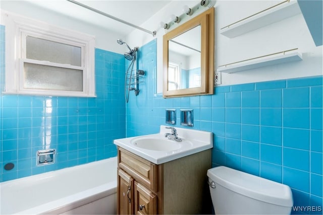 full bathroom featuring toilet, tile walls, vanity, and  shower combination