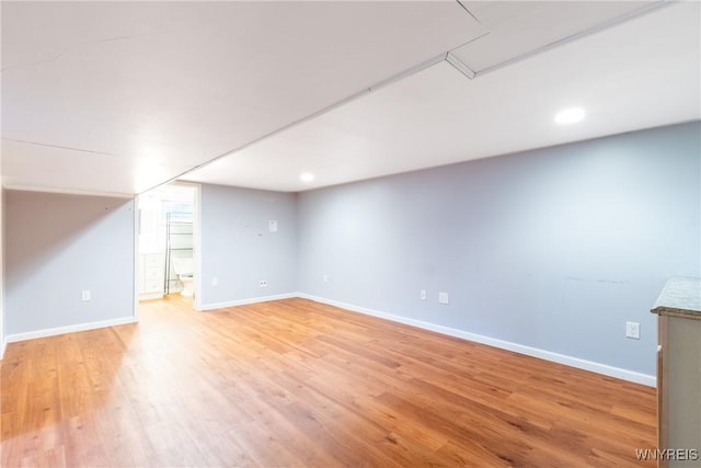 finished basement with light wood-style flooring, recessed lighting, and baseboards