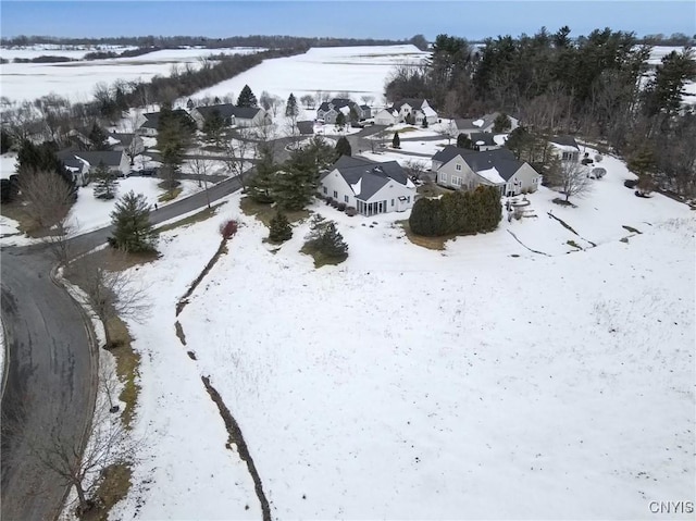 snowy aerial view featuring a residential view