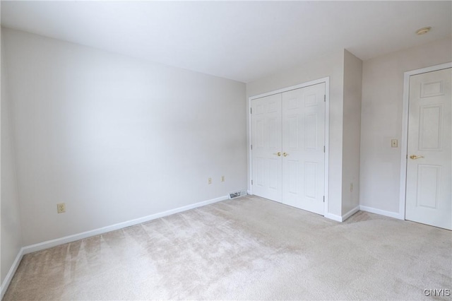 unfurnished bedroom featuring a closet, carpet flooring, and baseboards