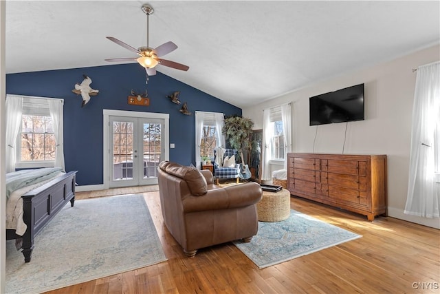 living area with wood finished floors, french doors, lofted ceiling, and ceiling fan