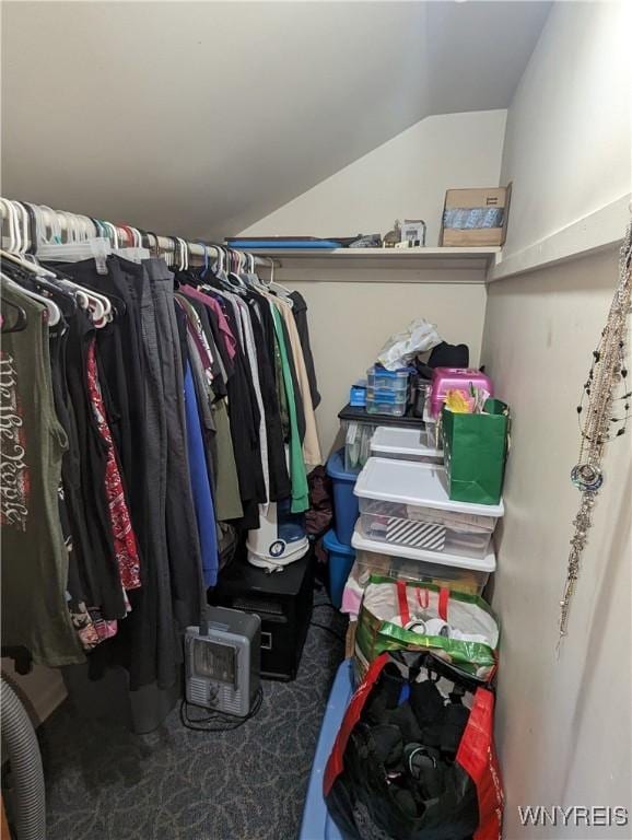 spacious closet with carpet flooring and vaulted ceiling