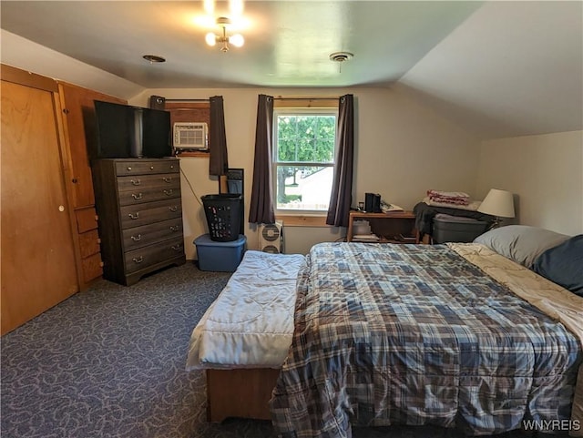 bedroom featuring visible vents, dark carpet, and lofted ceiling