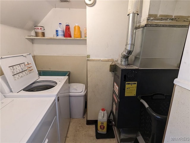 washroom with washer and dryer, heating unit, and laundry area