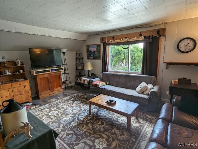 living area with lofted ceiling and wood finished floors