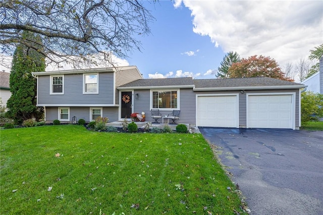 split level home featuring a front lawn, an attached garage, and driveway