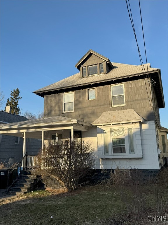 back of house featuring a porch