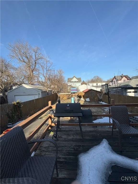 deck featuring grilling area and a fenced backyard