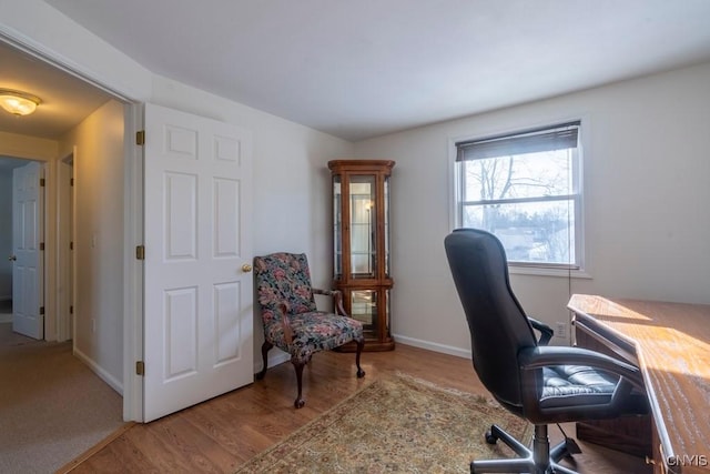 office space featuring baseboards and wood finished floors