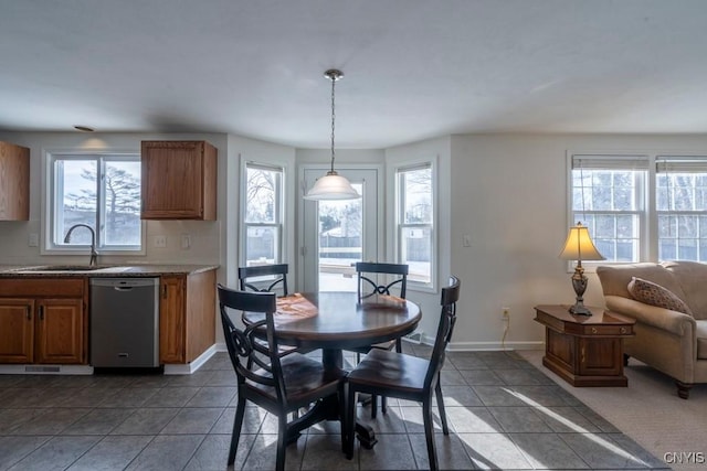 dining room with dark tile patterned flooring and baseboards