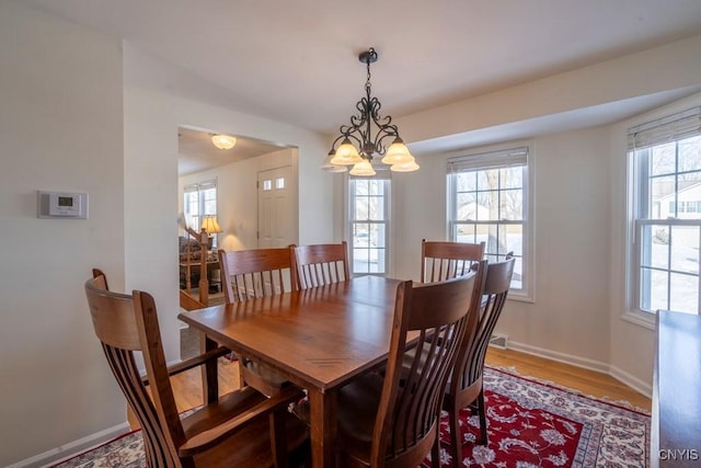 dining room featuring baseboards and light wood finished floors