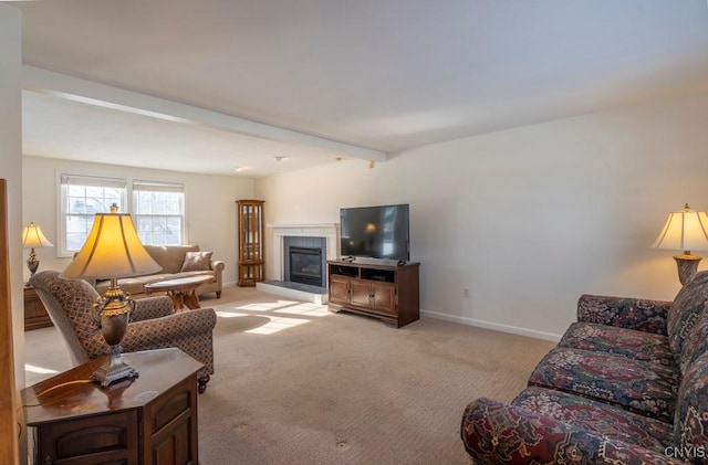 living room featuring a tiled fireplace, beamed ceiling, light colored carpet, and baseboards