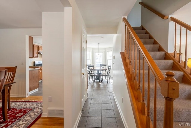 interior space featuring visible vents, stairs, and baseboards