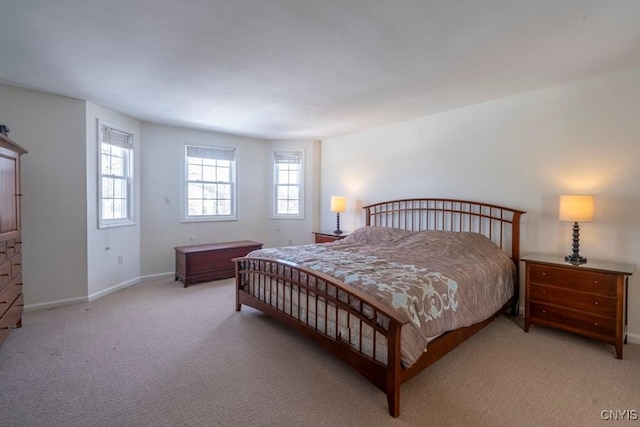 bedroom featuring baseboards and light carpet